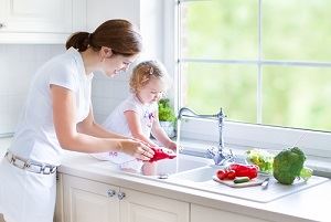 Child at sink, lowering hot water temperature