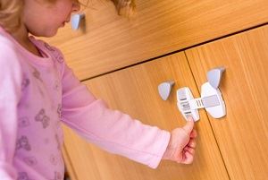 Child safety latches for cabinets